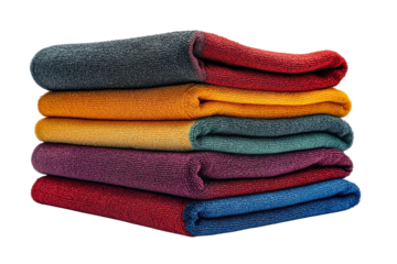 A stack of vibrant richly textured towels in autumnal hues neatly folded against a stark black background Soft shadows enhance the on transparent background