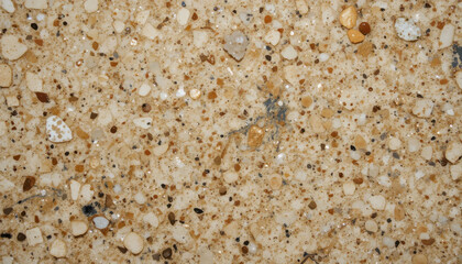 Fototapeta premium Close-up of a textured surface with various small stones and grains.