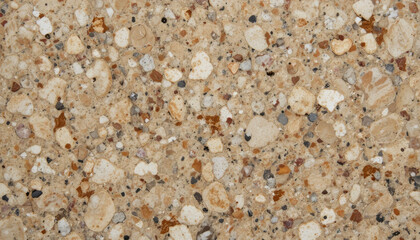 Fototapeta premium Close-up of a textured stone surface with various aggregates.