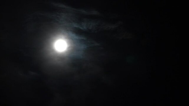 Victoria Falls, Zimbabwe - April 11, 2025: The rising full moon on the misty sky over Victoria Falls in Zimbabwe
