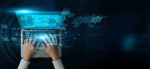 Man using a laptop with Big Data on the keyboard analyzing and developing various information about...