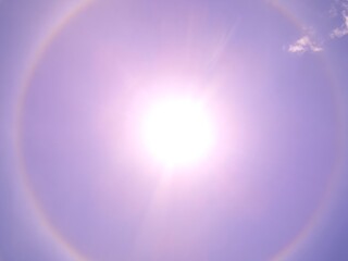 Sun halo in clear sky with visible atmospheric optical phenomenon