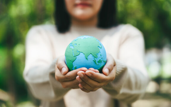 World Environment Day, Earth globe in woman hand to protect and save clean planet, Environmental care for sustainable. eco environment and ESG concept.