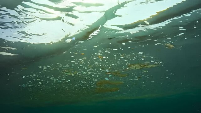 Microplatics In Water. Plastic Fragments Or Particles In Ocean. Ocean Pollution