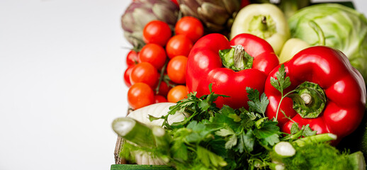 Farm grown organic vegetables on white background with copy space.