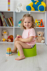 Child sitting on potty. Toddler potty trained