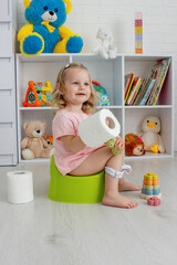 Child sitting on potty. Toddler potty trained