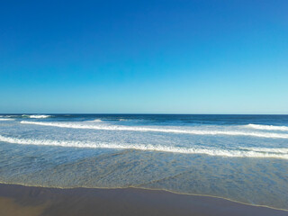 Oceans waves lapping the shore line of the beach