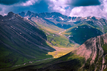 Mountain landscape with blue sky.  Panoramic view from the top of Sonmarg, Kashmir valley in the Himalayan region. Serene meadows, alpine trees, wildflowers on the trails of Great Lake of Kashmir Trek