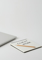 Minimalist workspace with a laptop and notes for client work  
