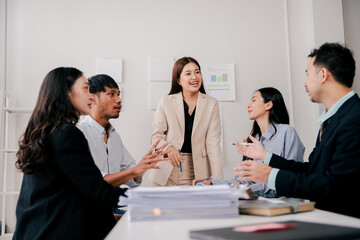 Brainstorming of young modern group. Team meeting to achieve goal. Business people discussing finance business and analysis. Teamwork concept in modern office. Calculating personal tax for client.