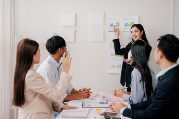 Brainstorming of young modern group. Team meeting to achieve goal. Business people discussing finance business and analysis. Teamwork concept in modern office. Calculating personal tax for client.