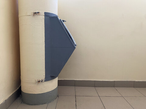 Garbage chute installed on the tube indoor multi-storey building. Waste disposal container. Convenient garbage and waste collection system