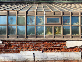 Fragment of abandoned greenhouse or orangery. Strong humidity and high heating temperatures led to rapid dilapidation of building. Construction design errors. Dilapidated building for demolished