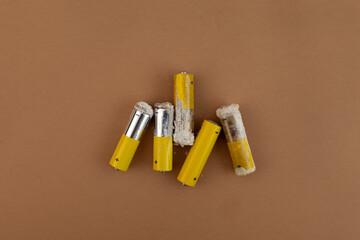 Old used batteries in poor condition. Oxidized and leaking alkaline batteries. Cathode is damaged,...