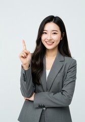 beautiful young woman wearing office clothes with expression has found an idea with hand pointing up happy face