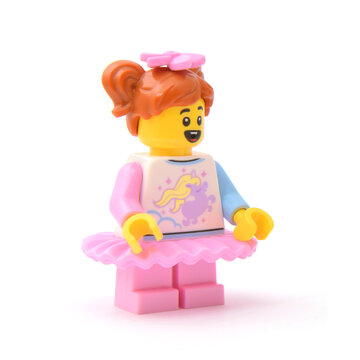 Lego minifigure of happy pretty girl in pink ballet skirt isolated on white. Editorial illustrative image of popular children plastic toy.