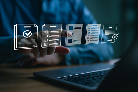 Businessman using a laptop to select digital checklist icons, representing task management, document completion, productivity, workflow organization, and online form processing.