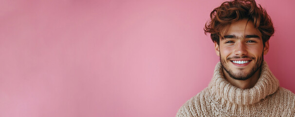 Cheerful young man with tousled hair wearing cozy knitted sweater smiling brightly in front of pink background with copy space Generative AI