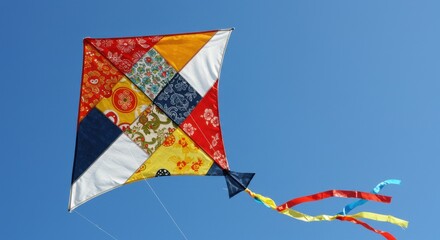 Flying Colorful Patchwork Kite in Bright Blue Sky Outdoor Activity