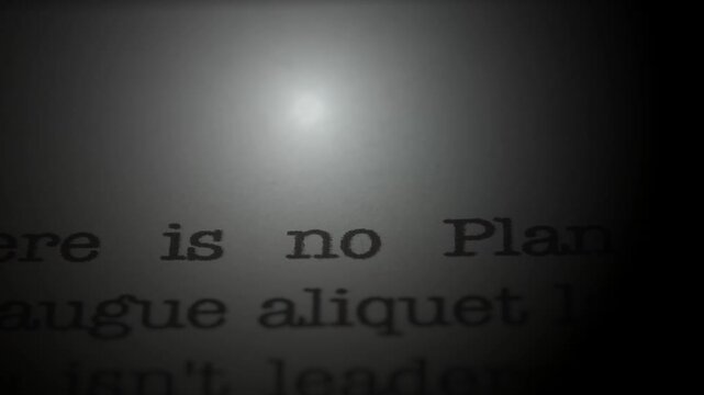 There is no planet B. Moving text printed on a page. Slow motion. A piece of paper with a phrase written in retro typewriter font. Spotlight effect. Dark dramatic video.