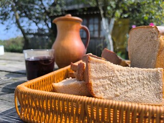 sliced bread on the table next to a glass of wine.