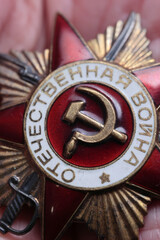 Extreme Close Up Macro View Of The Center Of The Soviet Order Of The Patriotic War, 1st Class, Showing Red Enamel, Hammer And Sickle Symbol. Vertical Historical Detail.