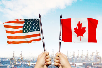 USA and Canada Flags Held by Hands at Shipping Port – Trade Relations Concept