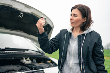 Female Driver Checks Light Lamp On Broken Car On Road