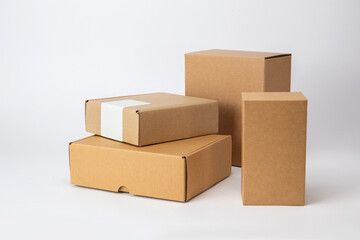 Paper container and brown cardboard boxes in various sizes isolated on white background