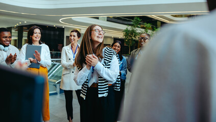 Friendly colleagues welcoming a new team member in a modern law firm environment