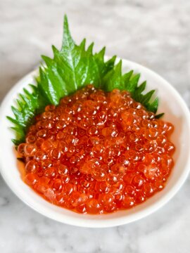 Salmon roe, Ikura , in white plate.