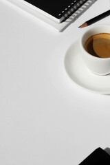 Business Still Life with Cup of Coffee, Notebooks and Pencil on White Desk. Business Meeting.