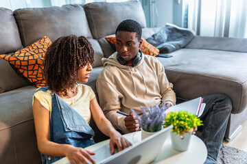 Students working from home on laptop and taking notes