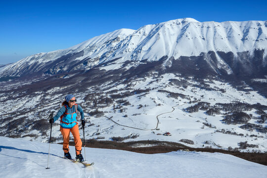 Woman backcountry skiing in the snowy mountains of Monte Mileto, Italy