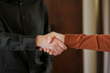 Close-up of a handshake between two business professionals indoors