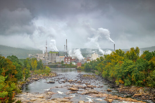 Rumford Paper Mill with smoke stacks by the Androscoggin River in Maine