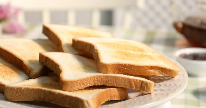 Tasty toasted bread slices on table, rotating