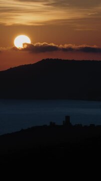 Scenic sunset over the ancient tower of the acropolis of Velia (Elea) in Ascea - Vertical video