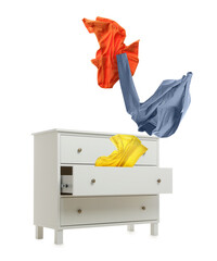 Clothes flying out of dresser on white background