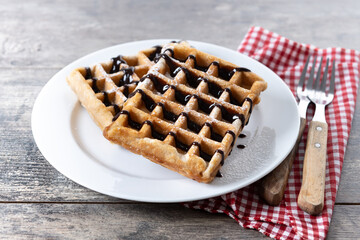 Belgian Waffles with chocolate on on wooden table