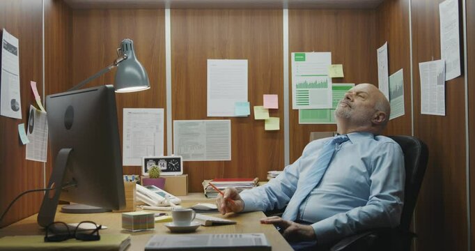 Bored inefficient Aemployee wasting time in the office