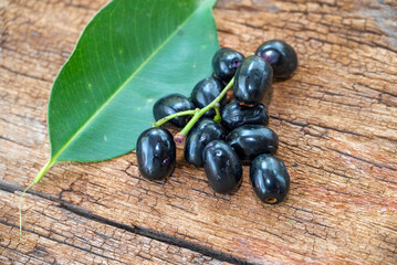 Jambolan plum, Java plum, Jambul( Syzygium cumini (L.) Skeels. on wooden background