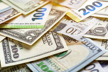 Closeup of assorted  banknotes.Money american hundred dollar bills.Currency of the USA, Britain and the European Union is scattered on the table. Currency, dollar, euro, pound, zloty.