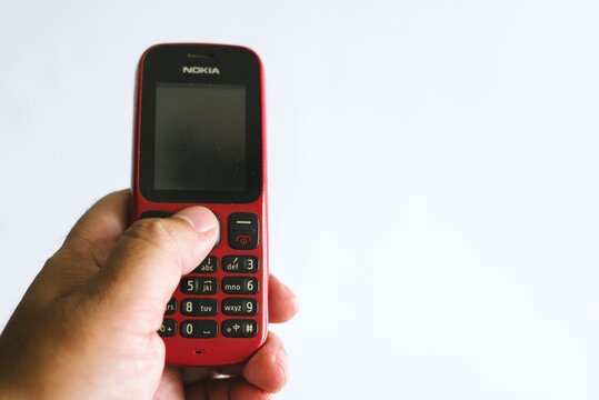 hand holding old feature mobile phone