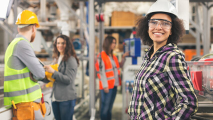 Workers in factory working with machines
