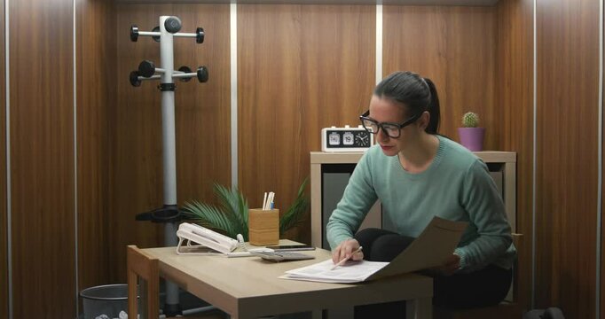 Businesswoman working in a tiny office