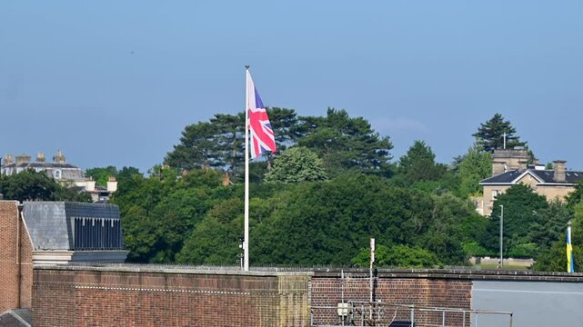 Union Jack British flag flying with a blue sky