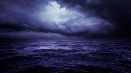 Dark stormy ocean at night with dramatic clouds.