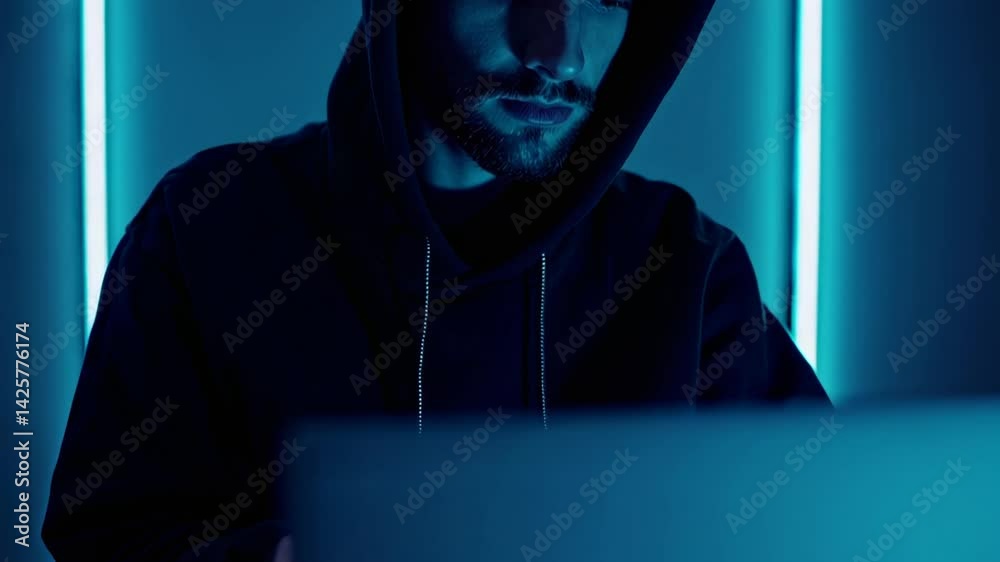Poster skilled programmers working on laptop in dimly lit room, blue neon lights casting mysterious glow ov